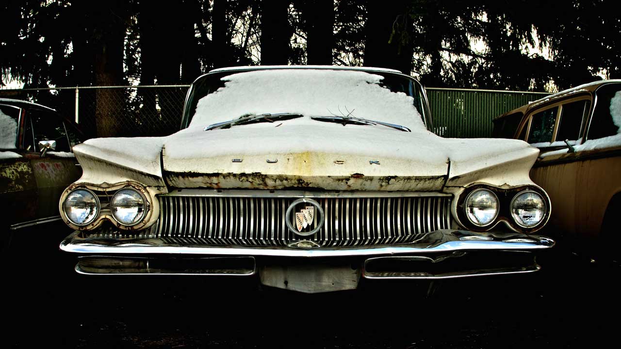 old rusty buick sitting outside