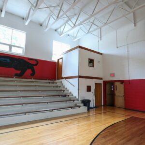 how did bleachers in a gymnasium get their name what does it mean and where did it originate