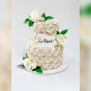 how did the tradition of serving a wedding cake at a wedding reception originate and what does it symbolize
