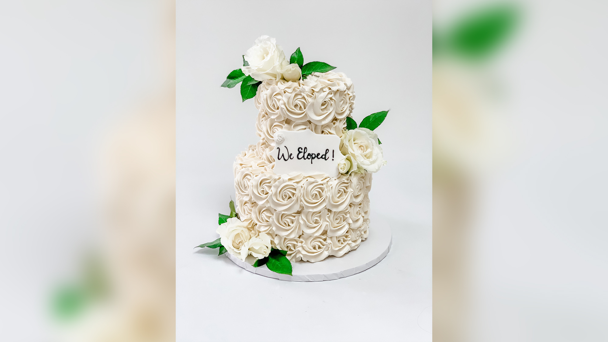 how did the tradition of serving a wedding cake at a wedding reception originate and what does it symbolize