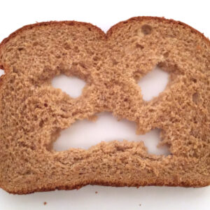 what does doesnt know which side his bread is buttered on mean and where did the expression come from
