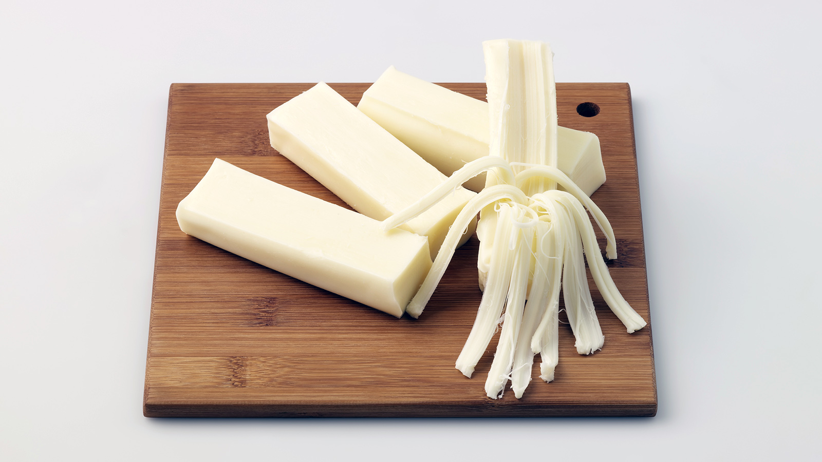 where did mozzarella cheese come from and how is string cheese made