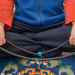 where did the practice of praying with a string of beads come from and when did the rosary originate