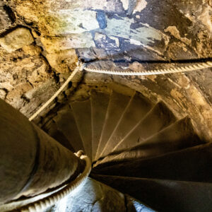 why do most spiral staircases ascend in a clockwise direction and how did they originate