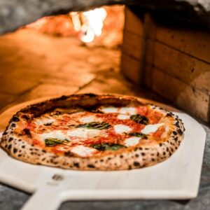 why does pizza taste better when baked in a brick oven or on a pizza stone