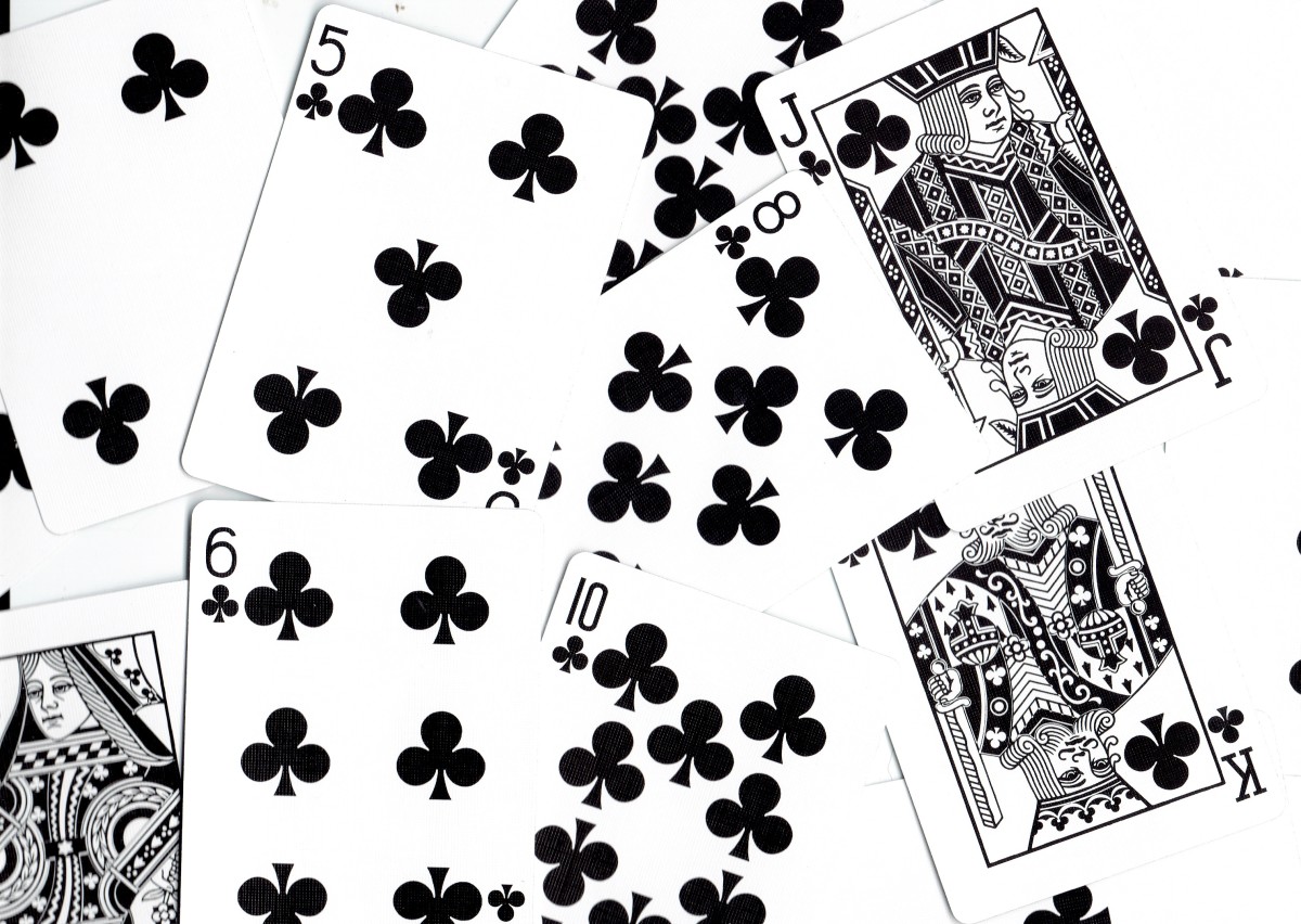why is clubs in a suit of cards in the shape of a black clover and where did it come from