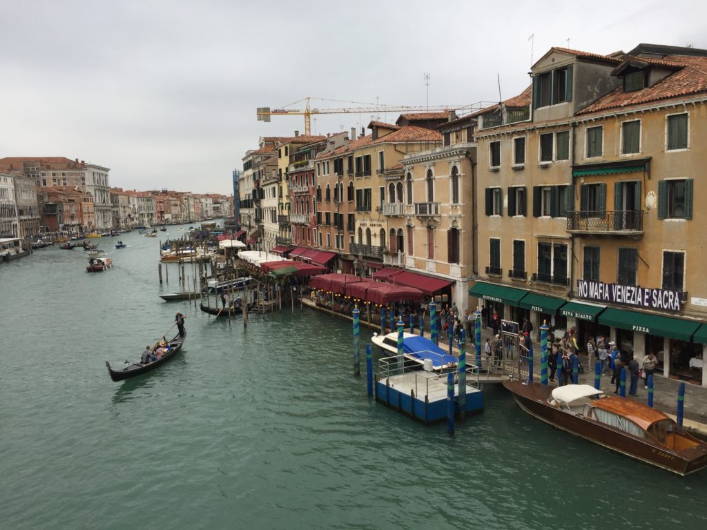 why is the city of venice in italy slowly sinking into the sea and how do people in venice get around