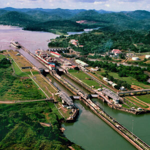 why was the panama canal built and how do they get ships through the panama canal