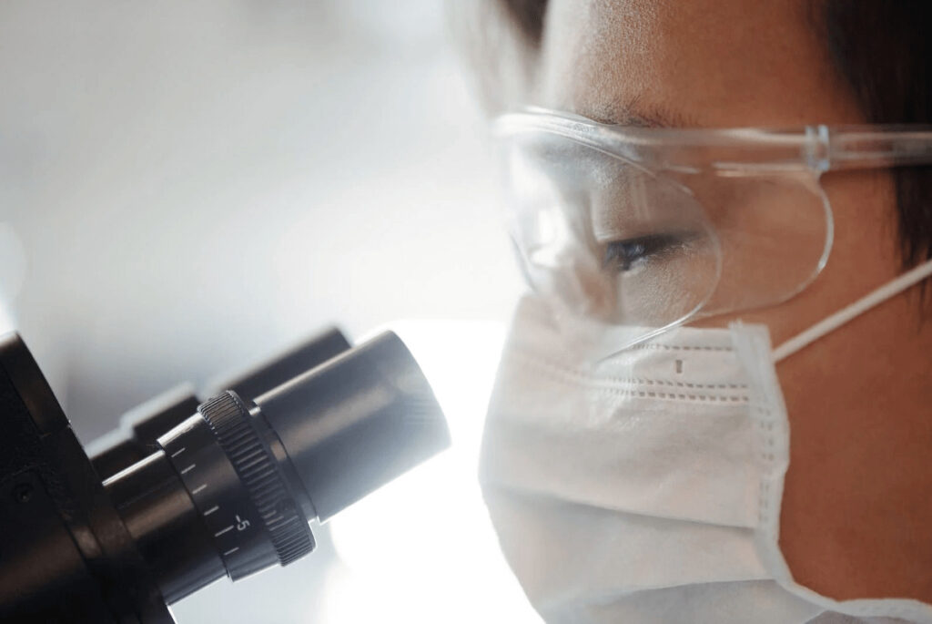 man looking through a microscope