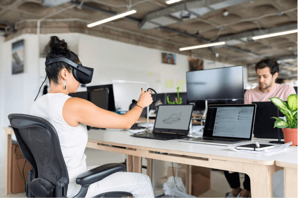 woman using laptop computer with vr headset