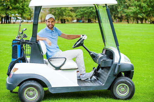 man driving golf cart