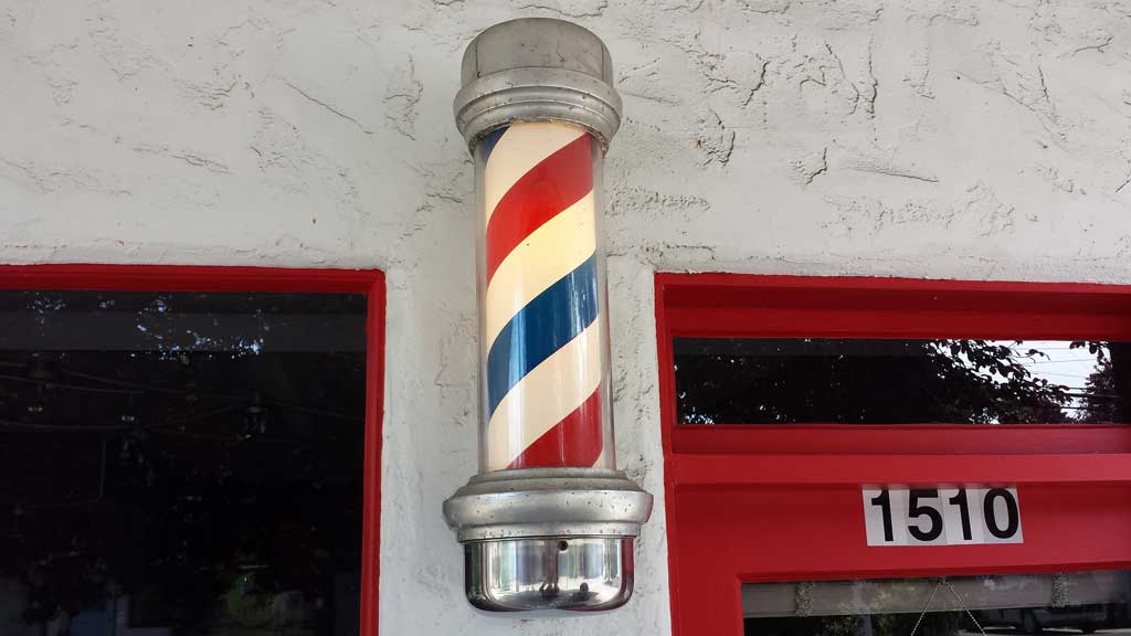 Why Do Barber Shops Have Red and White Poles Outside?